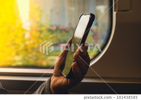 Close-up shot of woman's hands tapping on mobile phone screen. Girl in plaid shirt using modern smart phone. template mock up copy space Close-up shot of woman's hands tapping on mobile phone screen. Girl in plaid shirt using modern smart phone. template mock up copy space 101438585