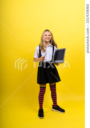 Little happy blonde kid girl 12-13 years laptop pc computer. Children lifestyle childhood concept. 101439060