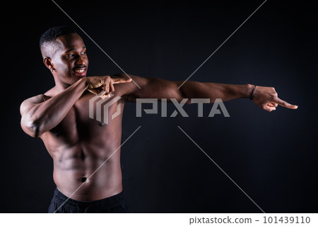 One young african muscular build man standing topless silhouette isolated on black background One young african muscular build man standing topless silhouette isolated on black background 101439110