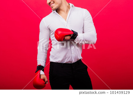 Handsome young businessman with boxing gloves. Studio red background 101439129