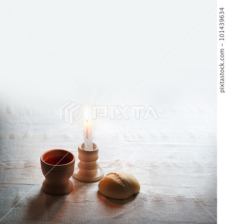 A bowl of wine and bread on the table. Communion symbols A bowl of wine and bread on the table. Communion symbols 101439634