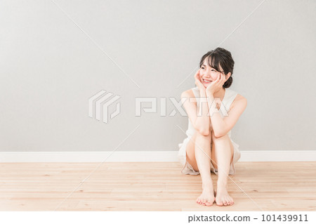 A beautiful Asian woman sitting in the living room of her house and thinking about her cheeks (beauty, diet, esthetic, hair removal, beautiful legs) A beautiful Asian woman sitting in the living room of her house and thinking about her cheeks (beauty, diet, esthetic, hair removal, beautiful legs) 101439911