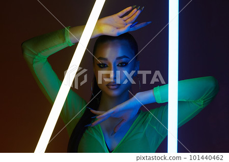beautiful young woman with neon lamp. Dancer girl in color lights 101440462