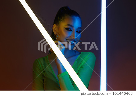 beautiful happy woman with neon lamp. Pretty Smiling girl 101440463
