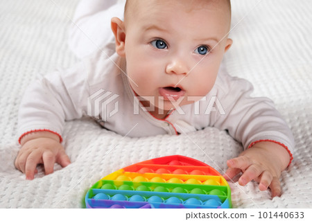 Happy Kid Playing with Pop It. Newborn Baby Playing with Simple Dimple. T Happy Kid Playing with Pop It. Newborn Baby Playing with Simple Dimple. T 101440633