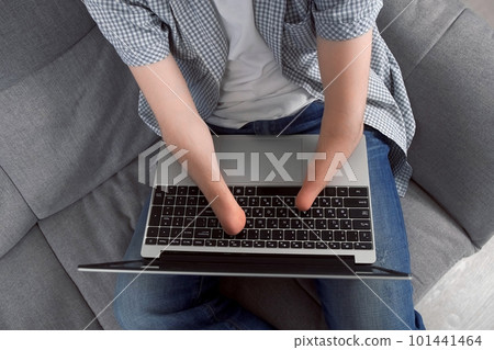 Disabled man with amputated two stump hands working typing on laptop at home. 101441464