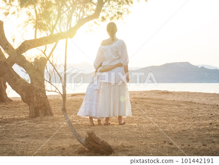 Nice sisters in white clothes, kid and teenage girl hugging and standing  101442191