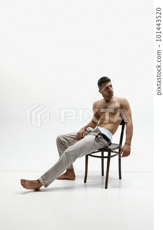 Elegant stylish handsome young man posing over white studio background. Textured muscular body shape Elegant stylish handsome young man posing over white studio background. Textured muscular body shape 101443520