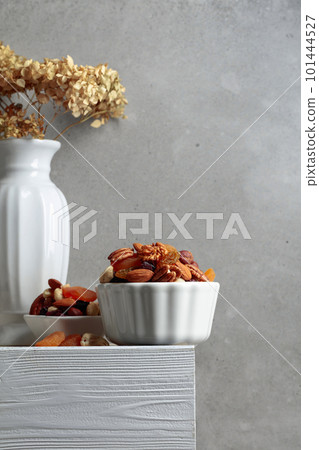 Dried fruits and nuts on a white wooden table. Dried fruits and nuts on a white wooden table. 101444527