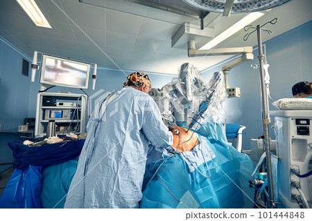 Surgical system with minimally invasive robot in a hospital. Robotic technological equipment, manipulator surgeon in a futuristic operating room. Medical innovation 3D endoscopy for robotic surgery in Surgical system with minimally invasive robot in a hospital. Robotic technological equipment, manipulator surgeon in a futuristic operating room. Medical innovation 3D endoscopy for robotic surgery in 101444848