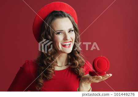 happy woman in red dress and beret against red background 101449276