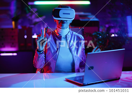 40 years old woman in virtual reality goggles in office 40 years old woman in virtual reality goggles in office 101451031