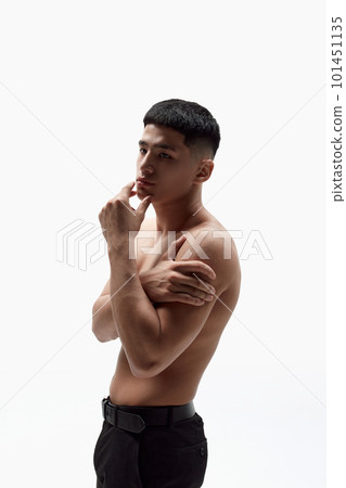 Portrait of asian handsome young man posing shirtless in trousers against white studio background. Spotless face, muscular body 101451135