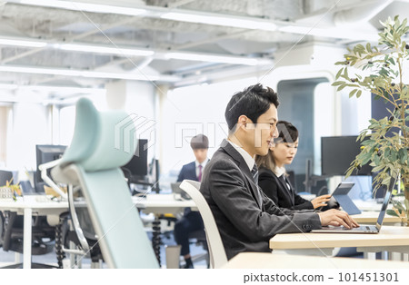 A businessman working in a free-address office A businessman working in a free-address office 101451301