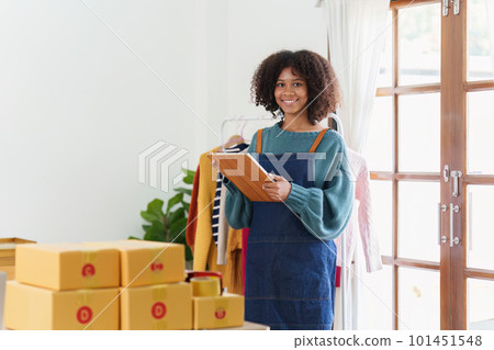 American African entrepreneur smile and checking online order. Successful SME entrepreneur concept American African entrepreneur smile and checking online order. Successful SME entrepreneur concept 101451548