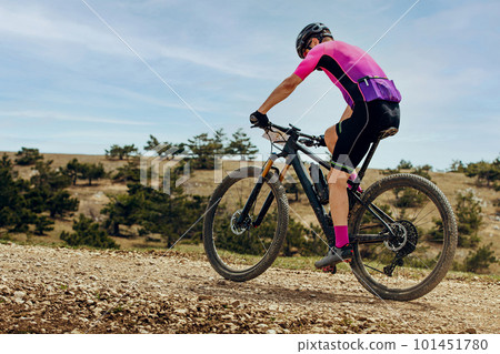 athlete mountainbiker biking uphill in cross-country cycling, outdoors summer race athlete mountainbiker biking uphill in cross-country cycling, outdoors summer race 101451780