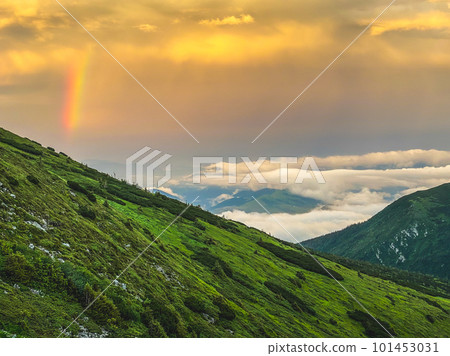 Rainbow and sunset clouds in Carpathian mountains. Ukraine Rainbow and sunset clouds in Carpathian mountains. Ukraine 101453031