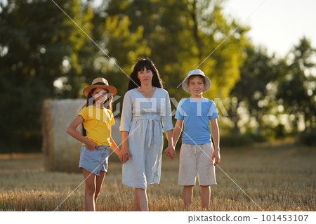 Cheerful family playing with their children's in the meadow Cheerful family playing with their children's in the meadow 101453107