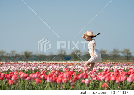 Girl playing in a flower field 101453321