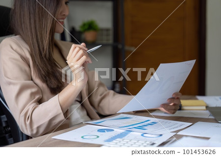 Business woman using calculator for do math finance on wooden desk in office. tax, accounting, statistics and analytic research concept Business woman using calculator for do math finance on wooden desk in office. tax, accounting, statistics and analytic research concept 101453626