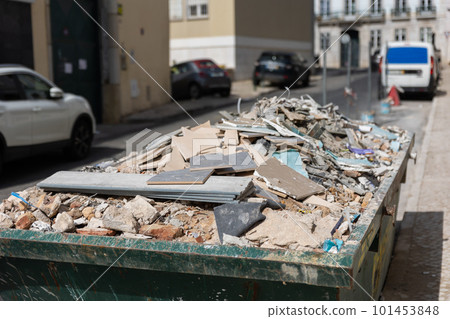 Construction waste in a container on the street Construction waste in a container on the street 101453848