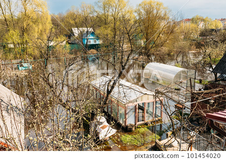 Vegetable Garden Beds In Water During Spring Flood floodwaters during natural disaster. Greenhouse Hothouse in Water deluge During A Spring Flood. inundation River 101454020