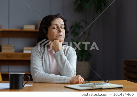 Sad tired ill sick lonely disappointed older senior woman sitting at home alone. Unhappy mature grandmother experiencing grief relative death bad news. Stressed elder lady suffering from loneliness Sad tired ill sick lonely disappointed older senior woman sitting at home alone. Unhappy mature grandmother experiencing grief relative death bad news. Stressed elder lady suffering from loneliness 101454460