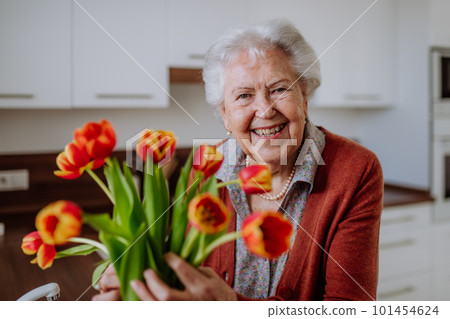 Portrait of senior woman with bouquet of tulips. Portrait of senior woman with bouquet of tulips. 101454624