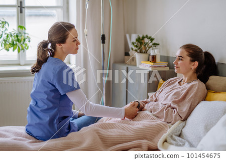 Young nurse taking care of teenage girl. Young nurse taking care of teenage girl. 101454675