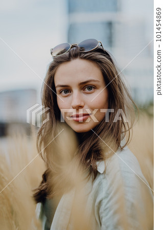 Portrait of happy young woman outdoor in city park with sunglasses. 101454869