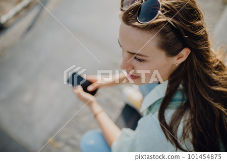 High angle view of young woman with smartphone. High angle view of young woman with smartphone. 101454875