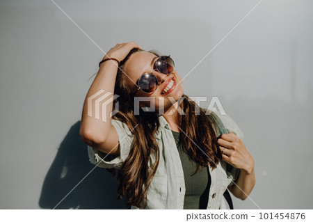 Portrait of happy young woman outdoor with backpack and sunglasses. Portrait of happy young woman outdoor with backpack and sunglasses. 101454876