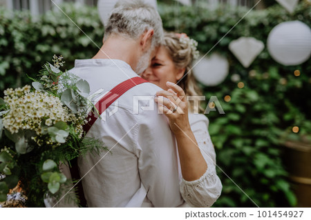 Close-up of bride and groom dancing at their outdoor wedding party. Close-up of bride and groom dancing at their outdoor wedding party. 101454927