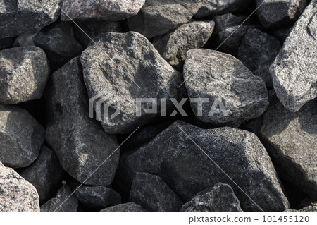 Dark gray stones covering the ground. Background photo texture 101455120