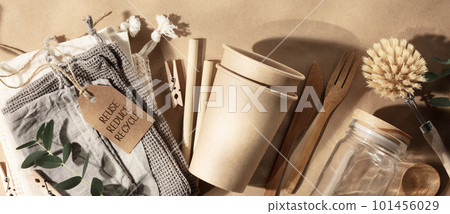 Banner Set of eco-friendly tableware on natural beige paper background with leaves shadows, flat lay stop plastic pollution 101456029