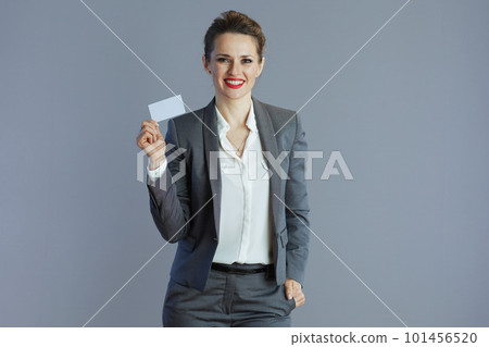happy young woman worker in grey suit isolated on gray happy young woman worker in grey suit isolated on gray 101456520
