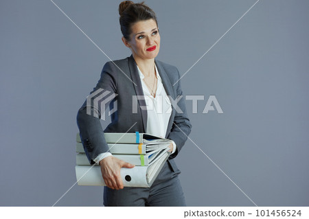 stressed 40 years old woman employee against gray stressed 40 years old woman employee against gray 101456524