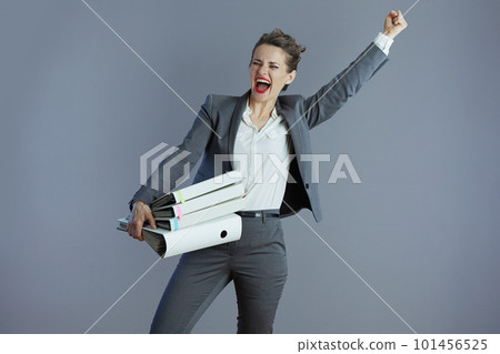 smiling stylish business owner woman rejoicing isolated on gray smiling stylish business owner woman rejoicing isolated on gray 101456525