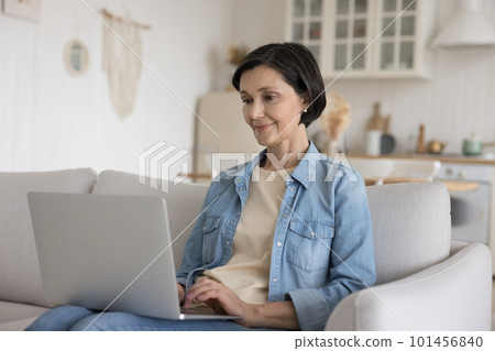 Focused positive senior freelance employee woman working at laptop Focused positive senior freelance employee woman working at laptop 101456840