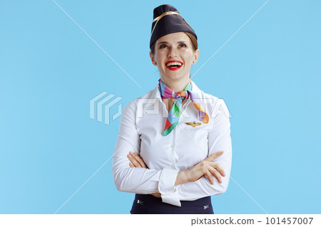 smiling stewardess woman on blue looking up at copy space smiling stewardess woman on blue looking up at copy space 101457007