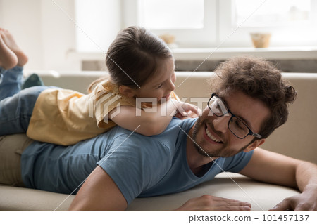 Pretty sweet girl resting on happy dads back, smiling, laughing Pretty sweet girl resting on happy dads back, smiling, laughing 101457137