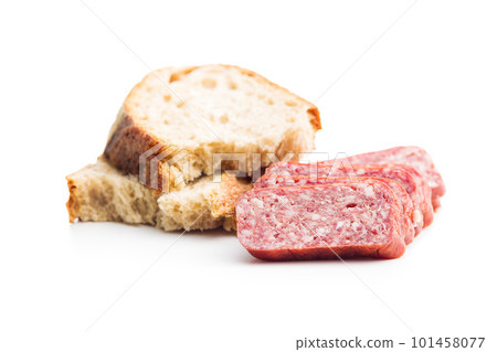 Smoked sausage. Sliced salami and bread isolatd on white background. 101458077