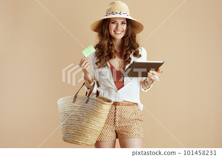 happy elegant woman using tablet PC on beige background happy elegant woman using tablet PC on beige background 101458231