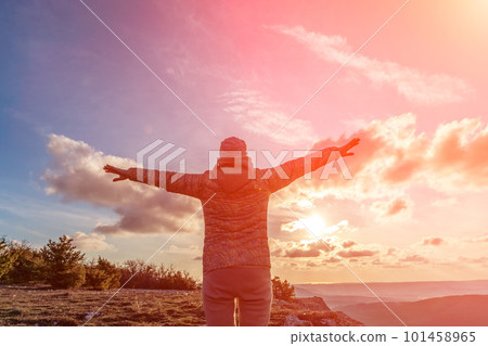 The girl at sunset. The girl stands with her back on the top of 101458965