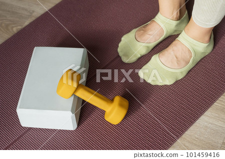 Workout and stretching accessories equipment in pilates studio. Yoga foam block, dumbbell and mat for fitness exercise. Healthy lifestyle. Workout and stretching accessories equipment in pilates studio. Yoga foam block, dumbbell and mat for fitness exercise. Healthy lifestyle. 101459416