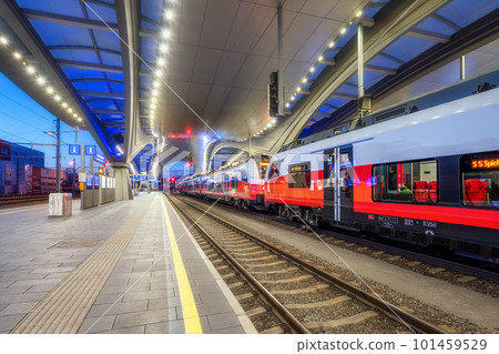 High speed train on the modern railway station at night High speed train on the modern railway station at night 101459529