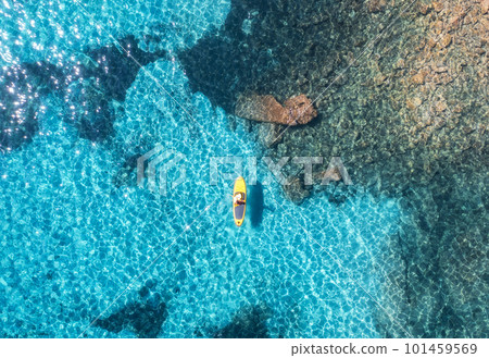 Aerial view of with man on sup board in blue sea at summer day Aerial view of with man on sup board in blue sea at summer day 101459569