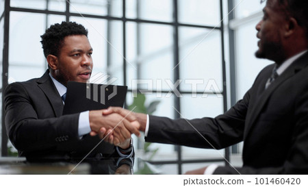 shaking hands with real estate agent in the office. 101460420