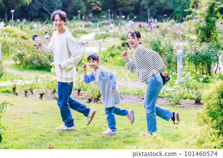 Girl and parents playing in the park Girl and parents playing in the park 101460574