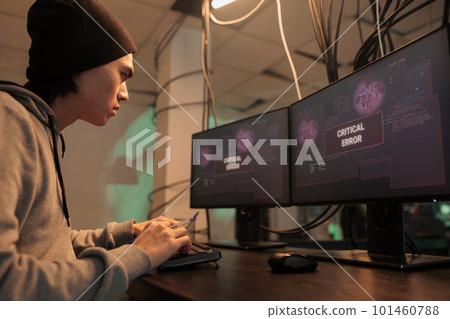 Young man being confused about critical error warning message on screen, trying to hack database program. Professional cybercriminal using malware to crack firewall encryption, data breach. Young man being confused about critical error warning message on screen, trying to hack database program. Professional cybercriminal using malware to crack firewall encryption, data breach. 101460788